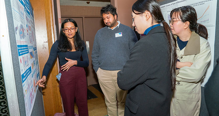 a group of people looking at medical poster